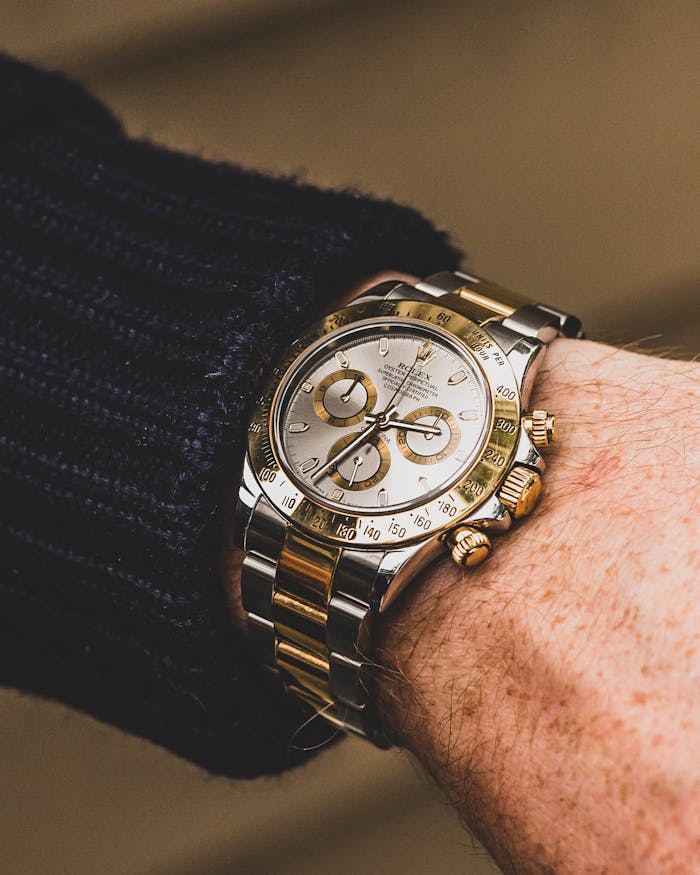 Close-up of a luxury wristwatch with gold and silver details, highlighting time precision.